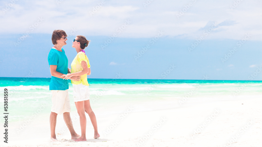 young couple walking on beach. honeymoon concept young couple walking on beach. honeymoon concept