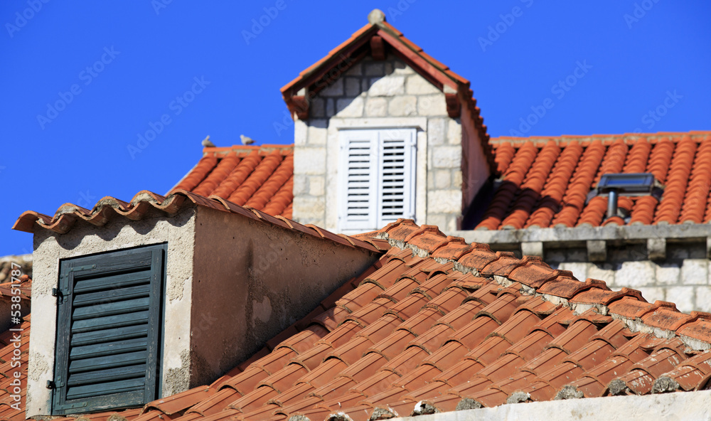 Terracotta roofs and dormer windows with shutters
