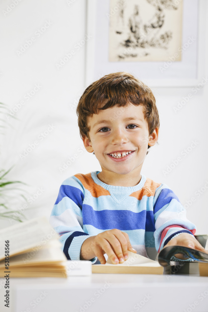 Smiling schoolboy studying in home. Smiling schoolboy studying in home.