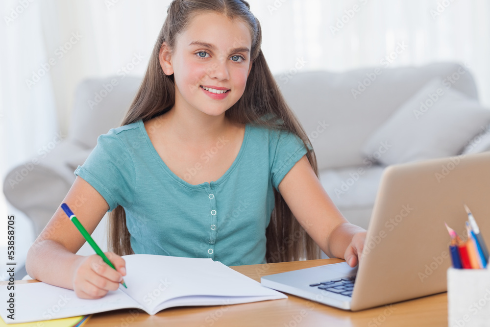 Smiling girl doing her homework Smiling girl doing her homework