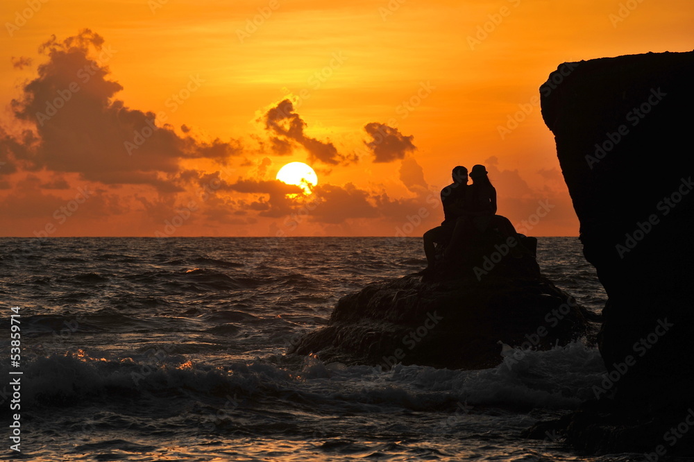 Romantic young couple sunset silhouette on beach. honeymoon