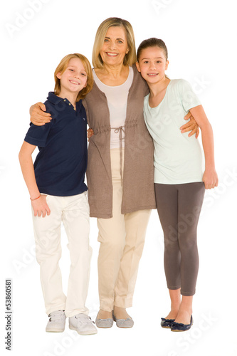 young grandmother with nephew and niece standing on white backgr