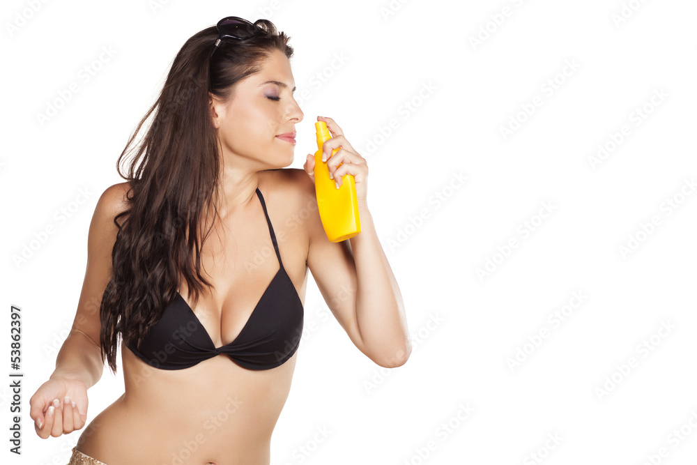 smiling beautiful girl enjoying the scent of her sunscreens smiling beautiful girl enjoying the scent of her sunscreens