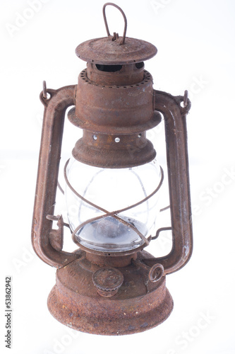 Old dusty oil lamp isolated on white