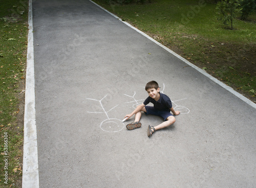 Child drawing family on asphalt
