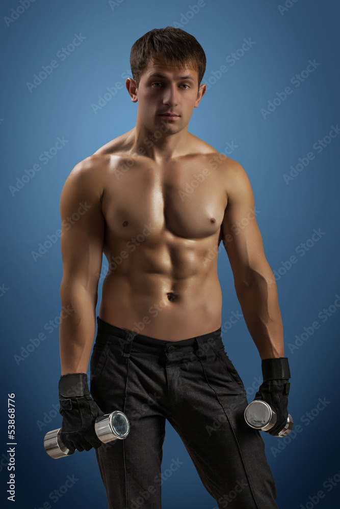 Fototapeta premium an athlette man with dumbbells