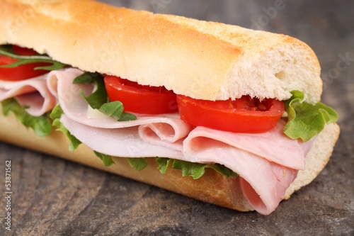 Baguette with ham, cheese, lettuce and tomatoes.