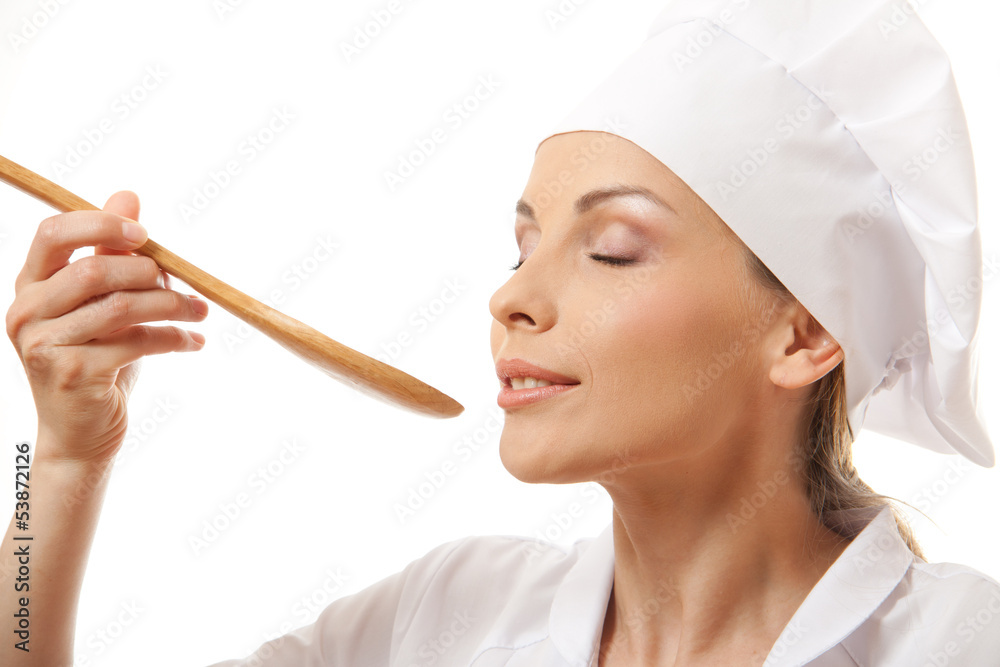 Woman cook eating with spoon, isolated on white background Woman cook eating with spoon, isolated on white background