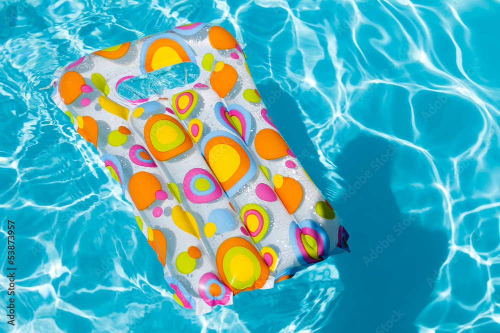 Naklejka premium Inflatable mattress floating in swimming pool