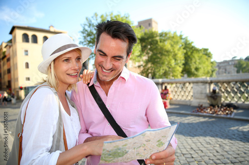 Tourists in Rome reading map on Saint Angel's bridge