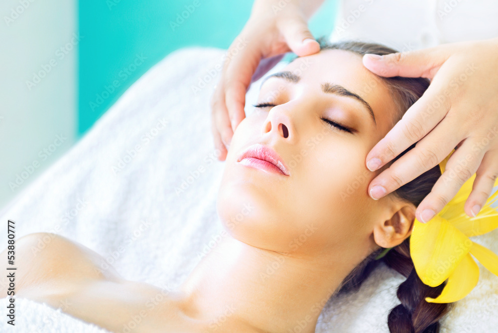 Woman receiving spa head massage