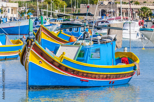Traditional Luzzu boat at Marsaxlokk harbor in Malta. photo