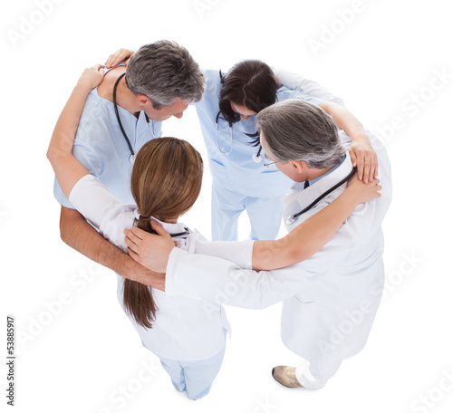 Group Of Doctors Making Huddle