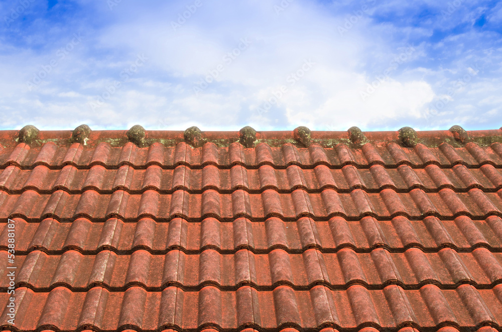 Tiled Roof with Fluffy Cloud Blue Sky