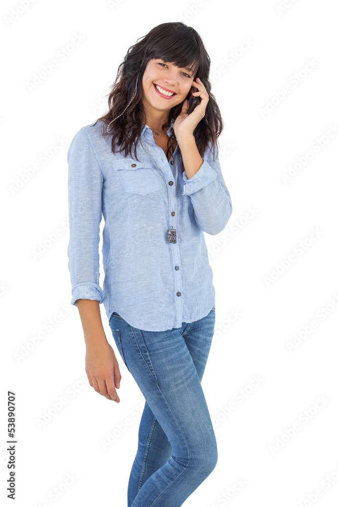 Cheerful brunette with her mobile phone calling someone Cheerful brunette with her mobile phone calling someone