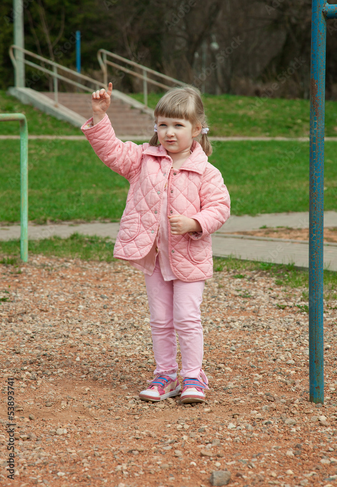 Smiling little girl playing in a park Smiling little girl playing in a park