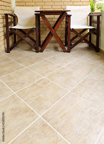 Chairs and table on tiled floor photo