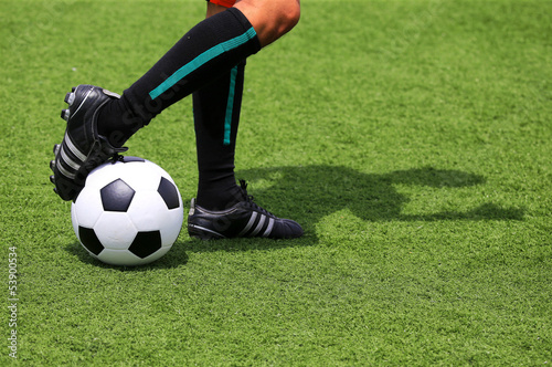 soccer ball with foot of player touching it with adumbration
