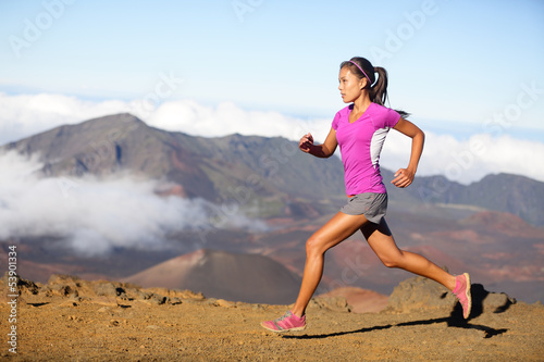 Female running athlete - woman trail runner © Maridav