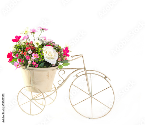 Fototapeta Naklejka Na Ścianę i Meble -  Bouquet of flowers in steel bucket on mini tricycle model