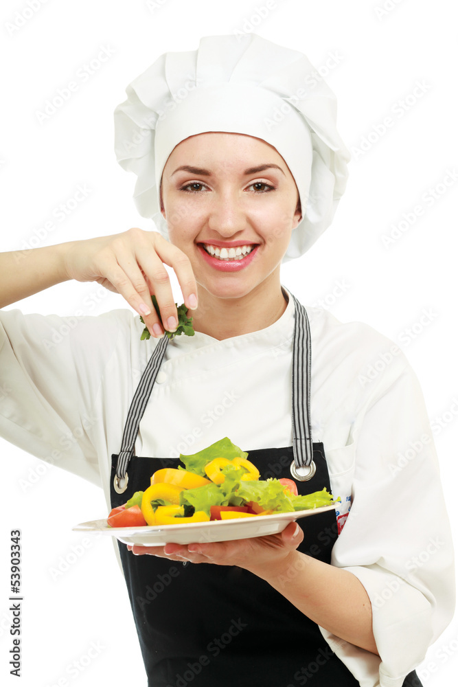 Portrait of a young cook in uniform preparing meal Portrait of a young cook in uniform preparing meal