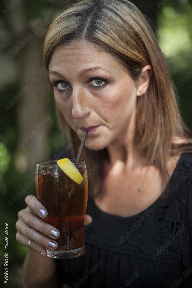 Blonde Woman with Beautiful Blue Eyes and Glass of Iced Tea Blonde Woman with Beautiful Blue Eyes and Glass of Iced Tea