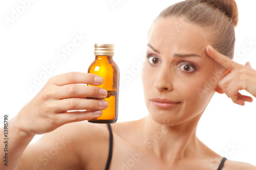woman holding a bottle of medicine, isolated on white background