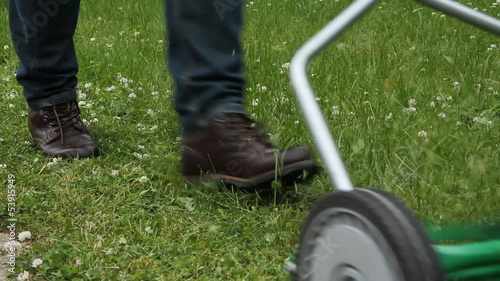 Cutting grass with a push mower. photo