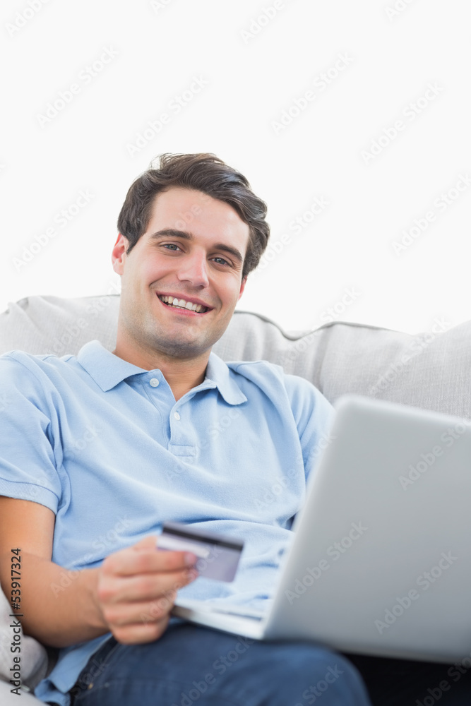 Portrait of a man using his credit card to buy online Portrait of a man using his credit card to buy online
