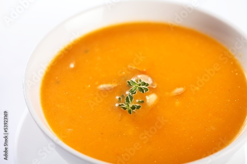 Bowl with pumpkin soup on white background