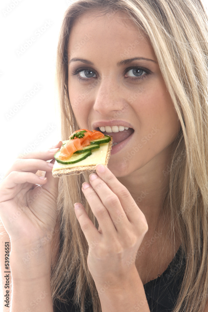 Young Woman Eating Smoked Salmon on a Cracker with Cheese Young Woman Eating Smoked Salmon on a Cracker with Cheese