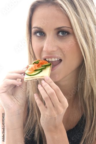 Young Woman Eating Smoked Salmon on a Cracker with Cheese