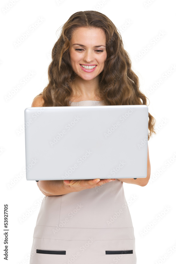 Happy young woman using laptop