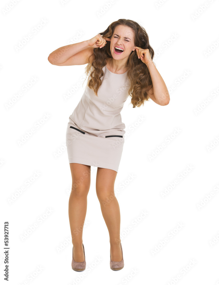 Full length portrait of frustrated young woman closing ears with Full length portrait of frustrated young woman closing ears with
