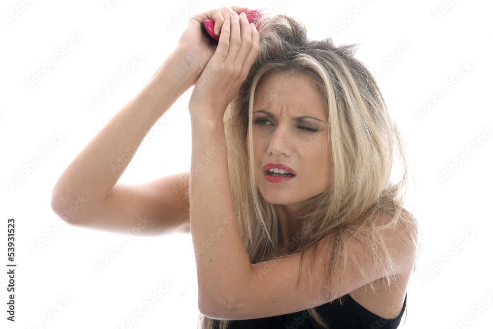 Model Released. Young Woman Brushing Tangled Hair