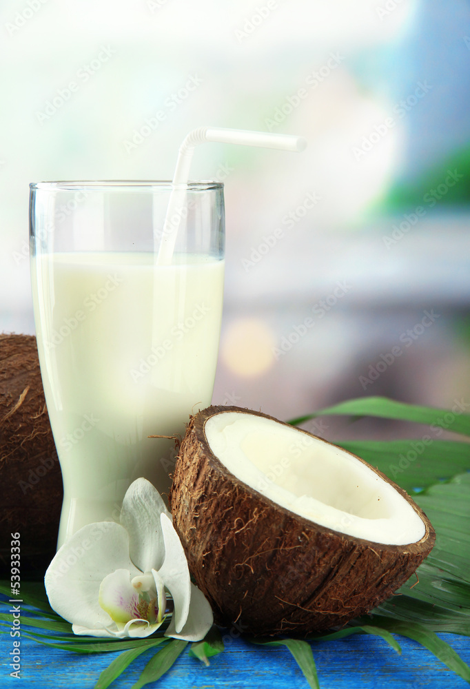 Coconut with glass of milk, on blue wooden table Coconut with glass of milk, on blue wooden table