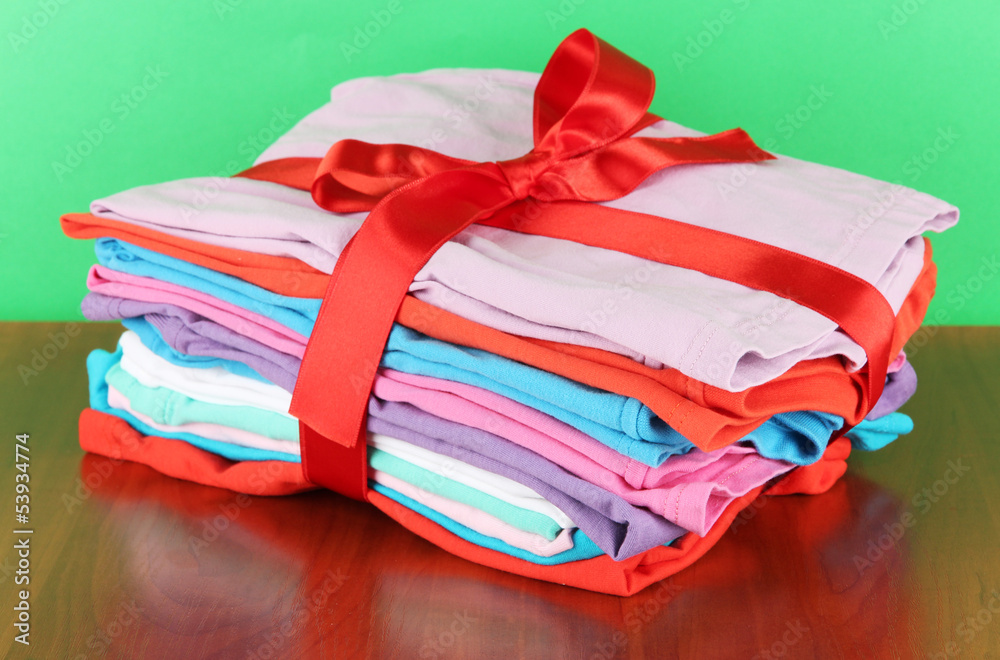 Pile of clothing with red ribbon and bow Pile of clothing with red ribbon and bow