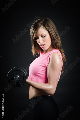 Hot blonde doing some exercise with dumbbell