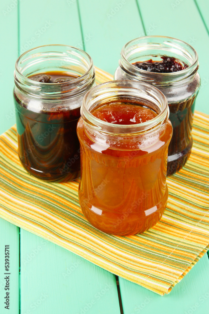 Tasty jam in banks on table Tasty jam in banks on table