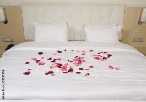 hotel room with big bed and red flowers