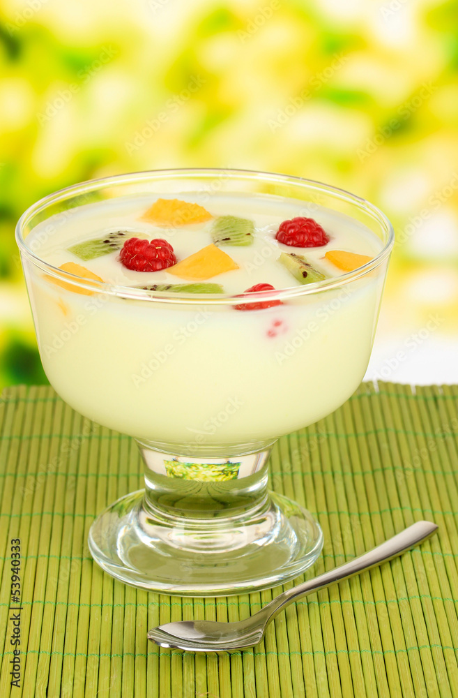 Delicious yogurt with fruit on table on bright background Delicious yogurt with fruit on table on bright background