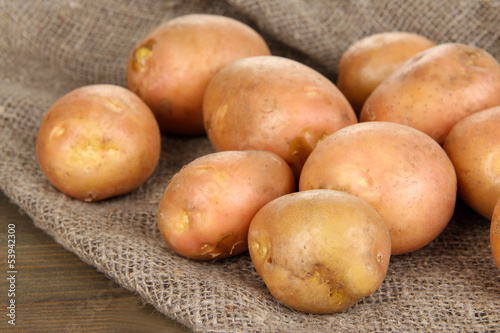 Potato on sackcloth, on wooden table