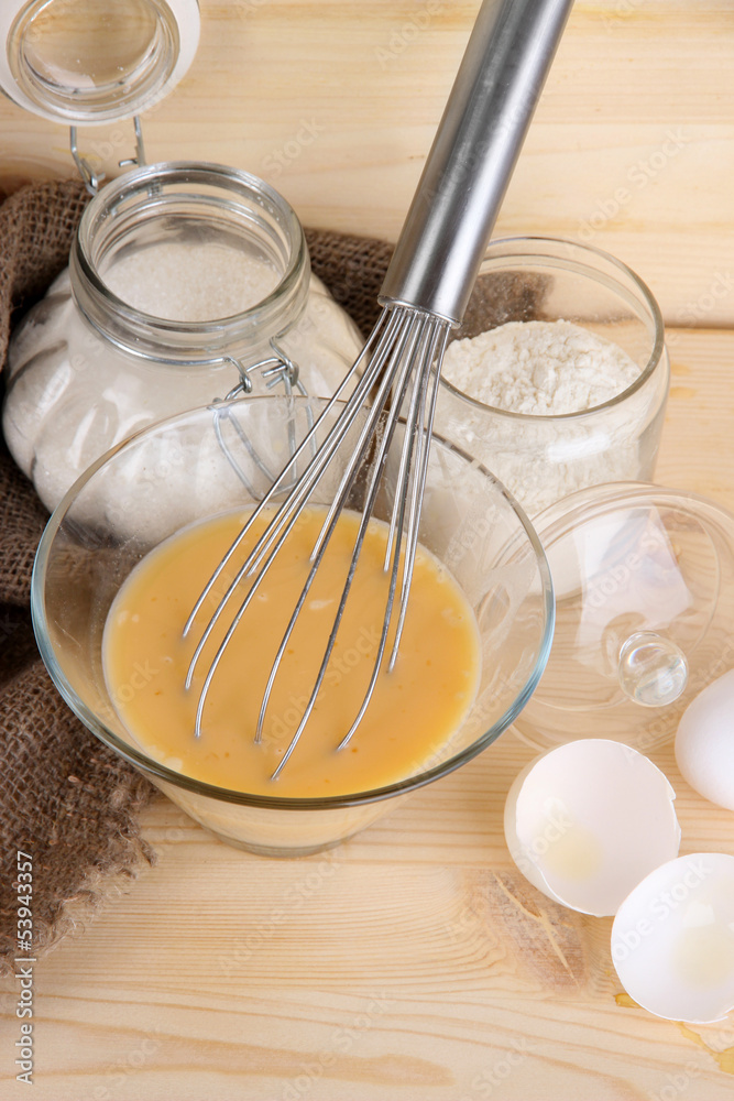 Ingredients for dough on wooden table on wooden background Ingredients for dough on wooden table on wooden background