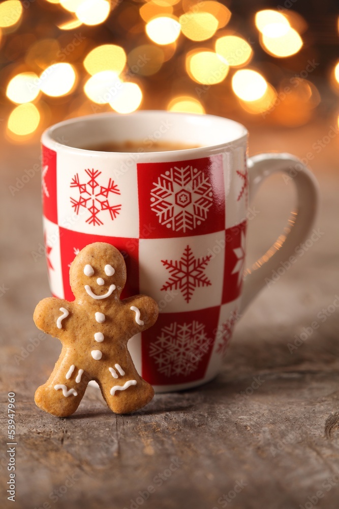 Mug with hot drink and gingerbread cookie.