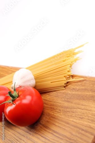 Spaghetti with ingredients on cutting board
