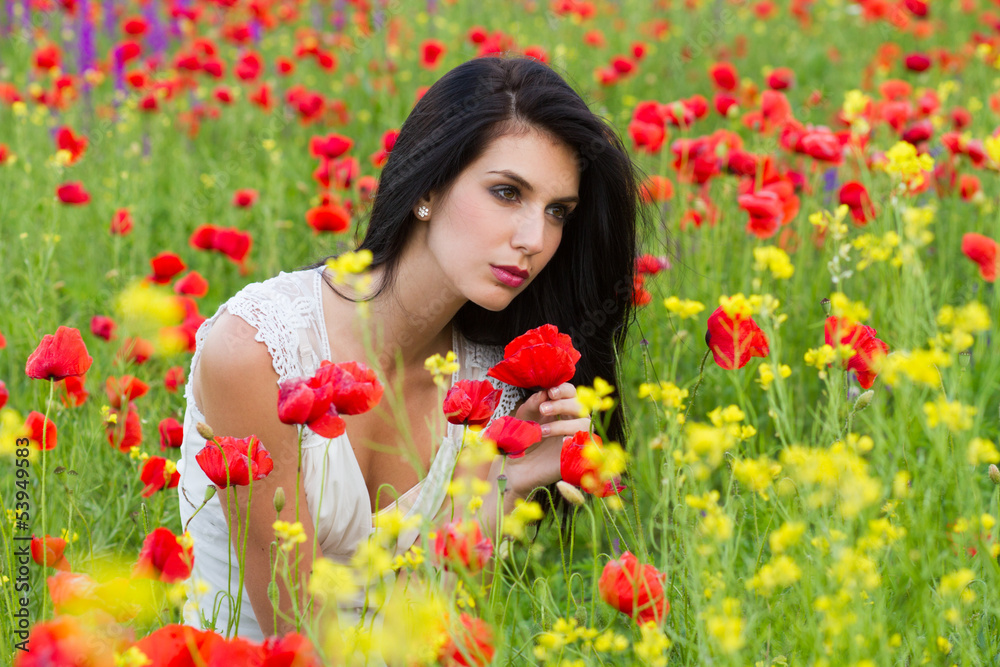 beautiful girl with long hair sitting in the poppy field beautiful girl with long hair sitting in the poppy field