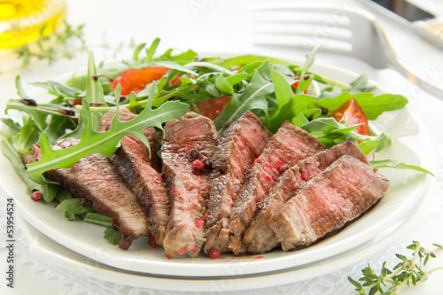 roast beef with salad of arugula and tomatoes.