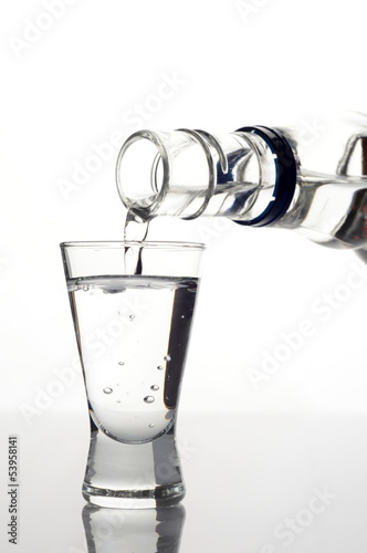 Obraz na plátne Vodka poured into a glass