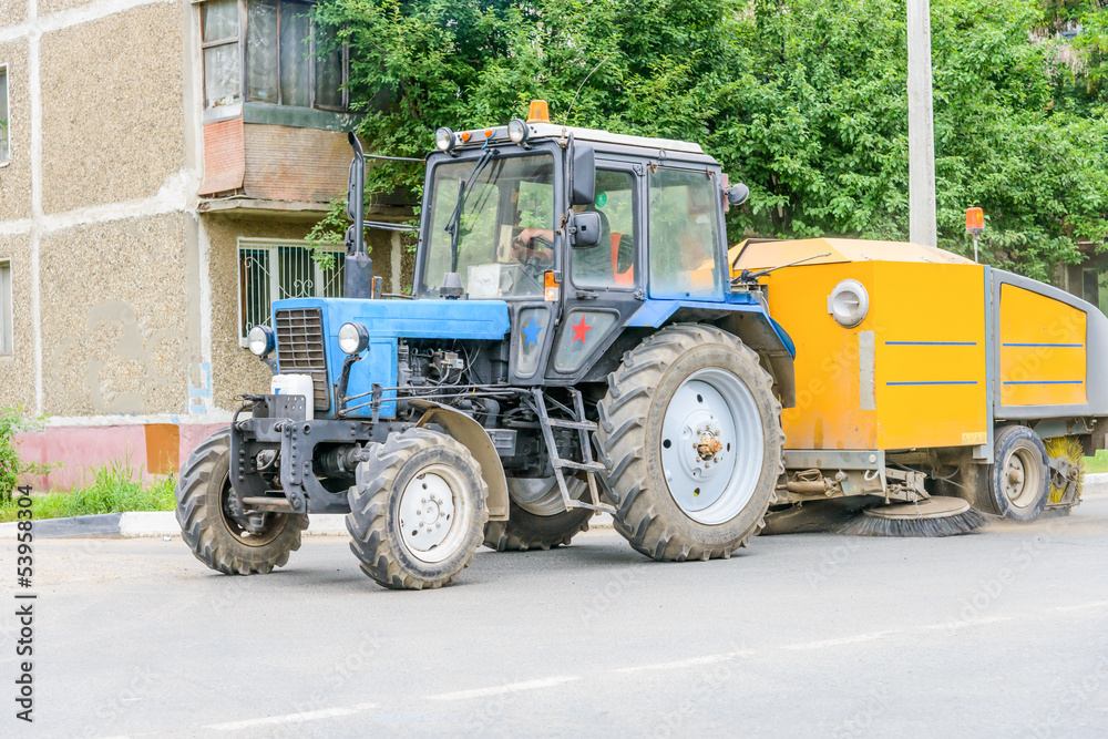 tractor cleans the street