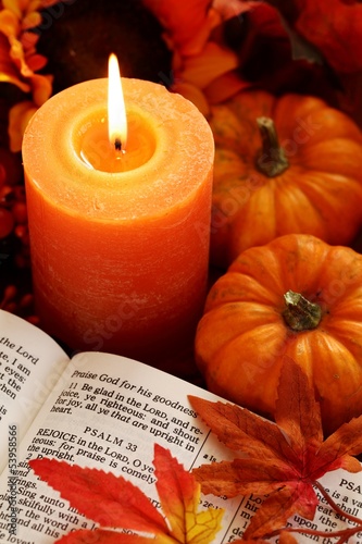 Fototapeta Naklejka Na Ścianę i Meble -  Open Bible, candle, and autumn decorations.